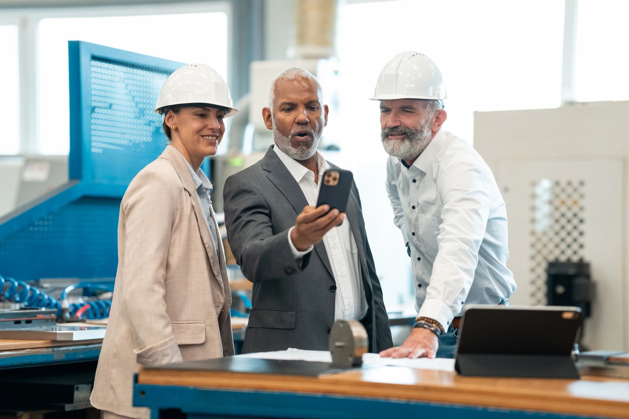 Engineers and business professionals reviewing plans on site