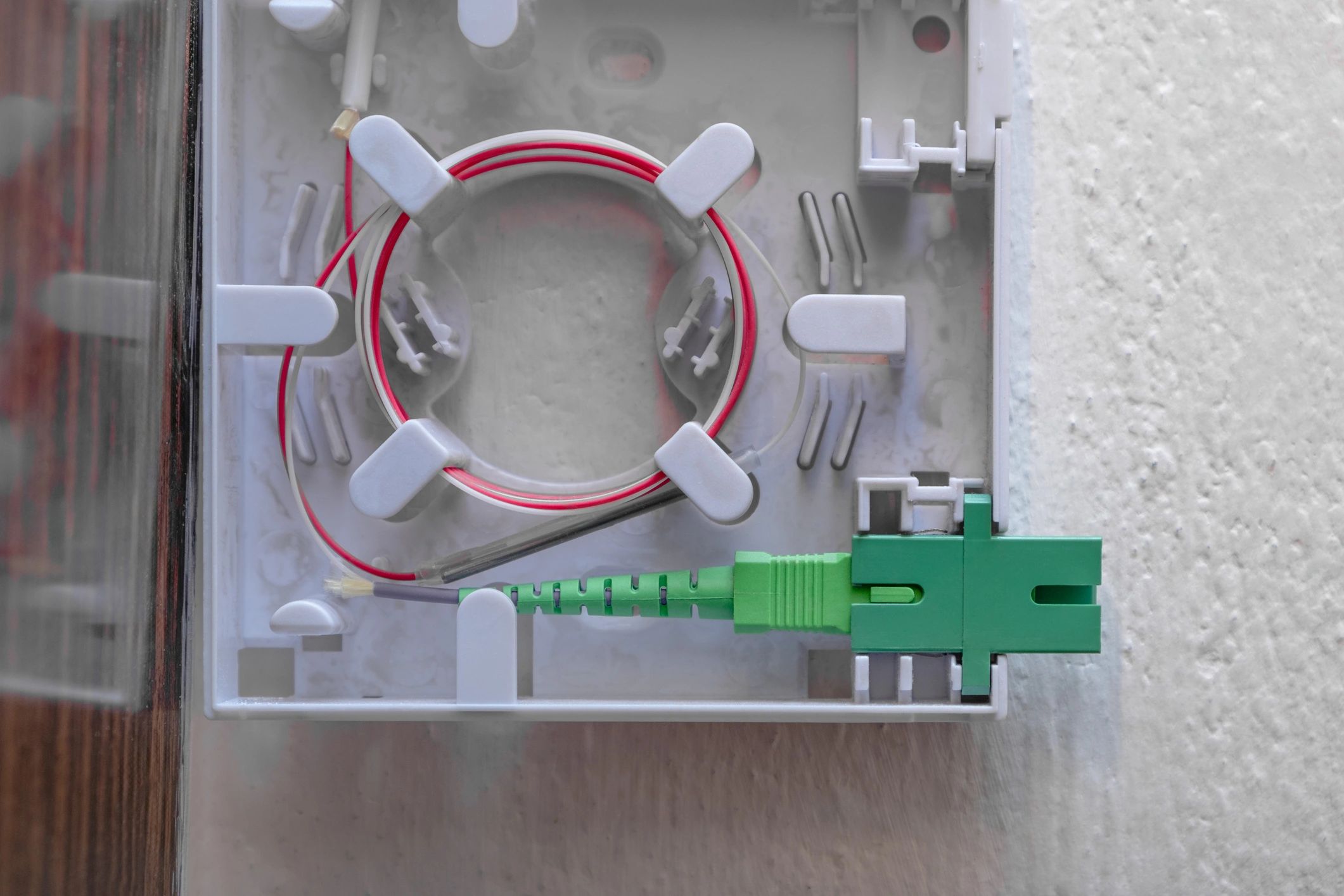 Fiber optic wall outlet and connector