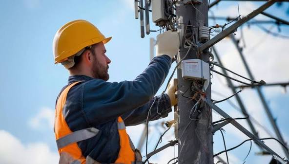 Telecom technician working on infrastructure equipment